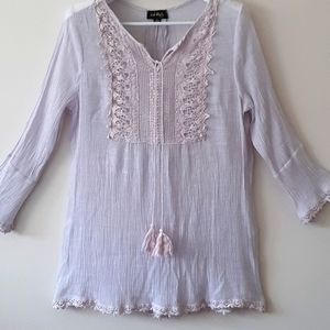 Bohemian type pull on blouse with embrodery.  Tassel tie up